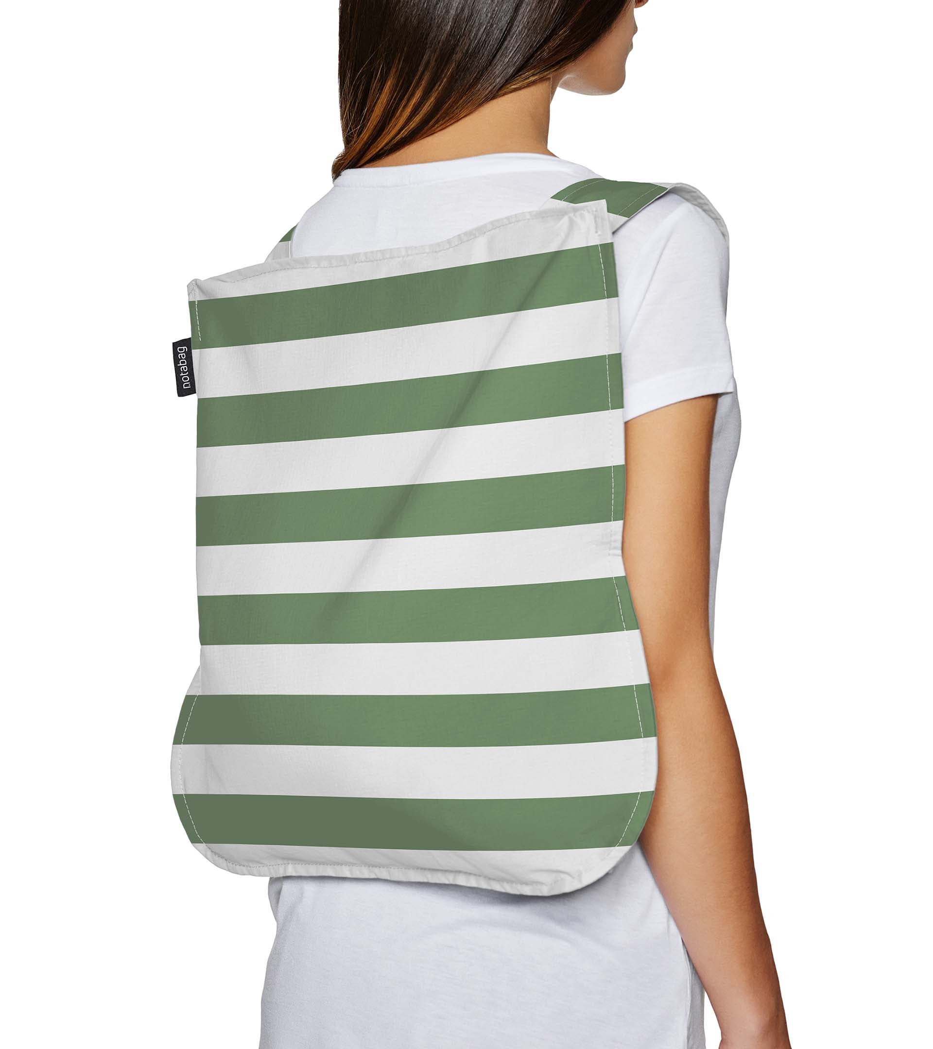 Notabag Foldable reusable backpack/tote in Olive stripe unfolded to backpack and on a models back