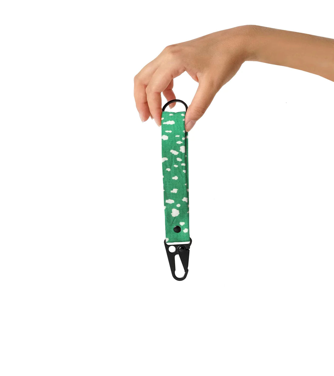 Hand holding Notabag Keychain in green sprinkle pattern